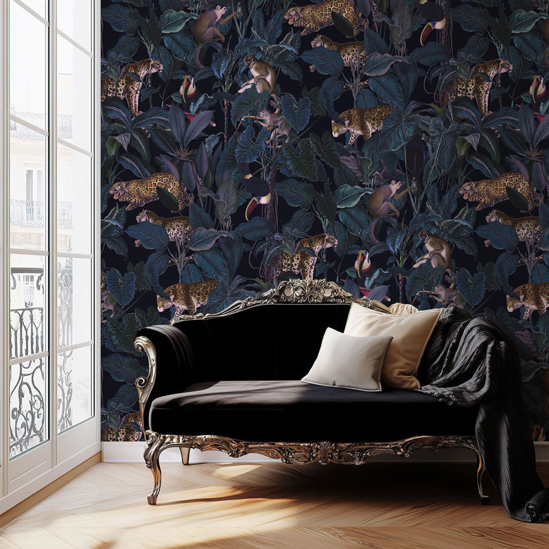 Decorative wallpaper with animal and leaf wallpaper in a room with a black sofa.