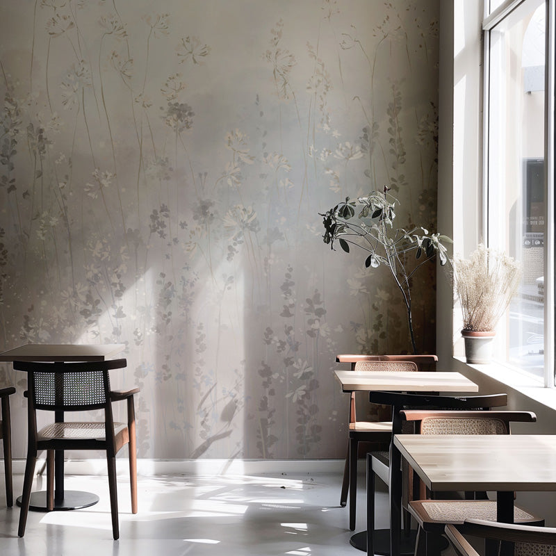Modern interior with floral wallpaper, wooden tables, and chairs in a well-lit room.
