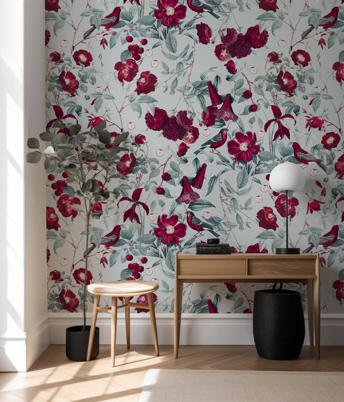 Room interior with floral wallpaper, wooden desk, and decorative items.