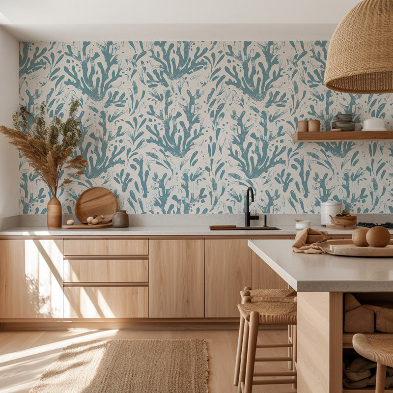 Modern kitchen with wooden cabinets, a white countertop, and a decorative blue wallpaper.