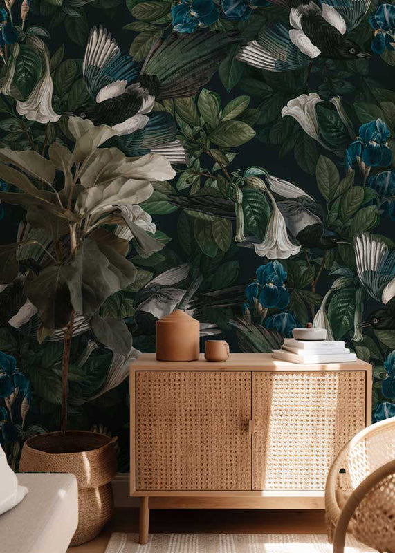 Room interior with wicker cabinet against a dark floral wallpaper