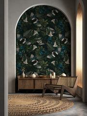 Decorative room with floral wallpaper, wooden furniture, and a rug.