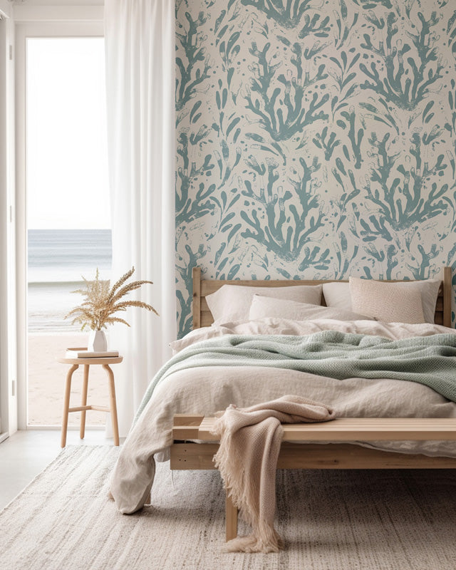 Bedroom with a bed against a wall featuring a blue wallpaper.