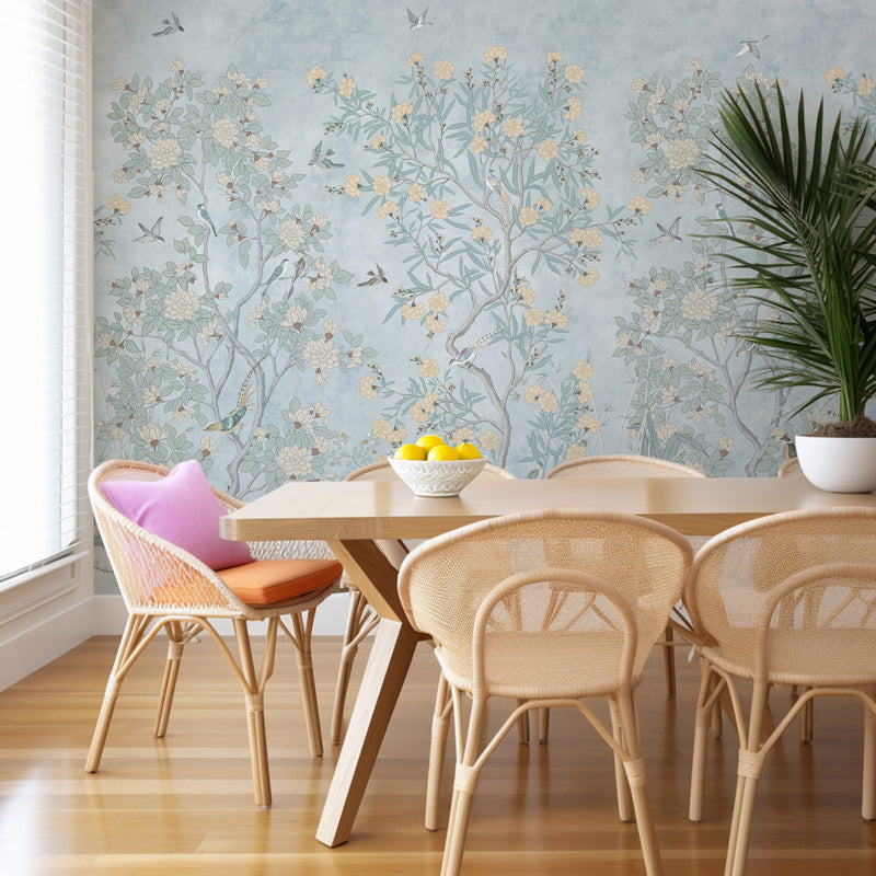 Dining room with floral wallpaper, wooden table, and wicker chairs.