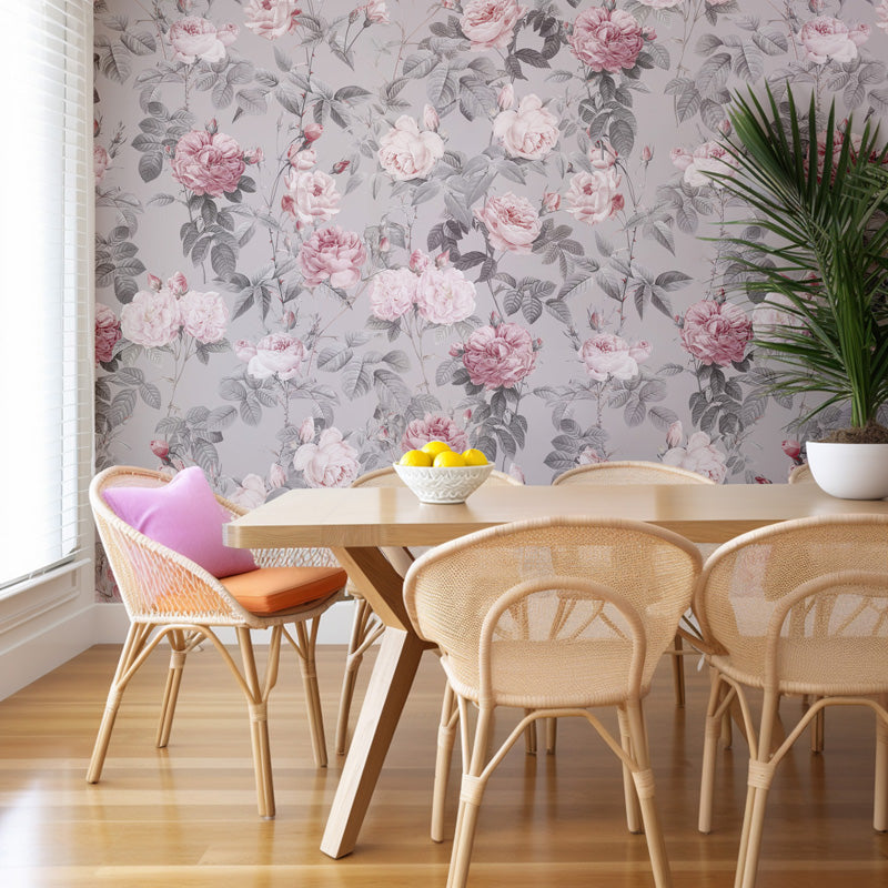 Dining room with floral wallpaper, wooden table, and wicker chairs.