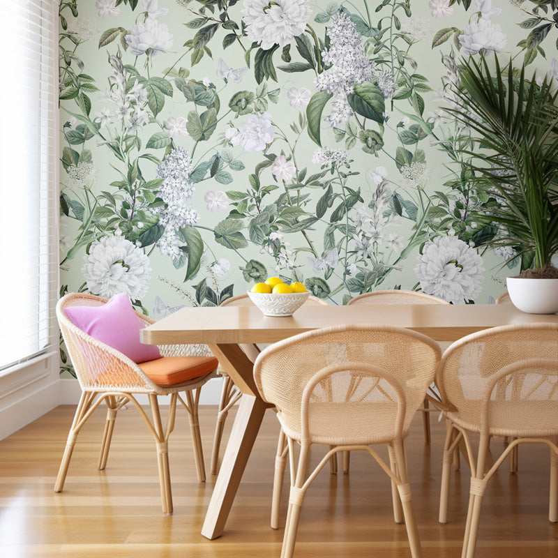 Dining room with floral wallpaper, wooden table, and wicker chairs.