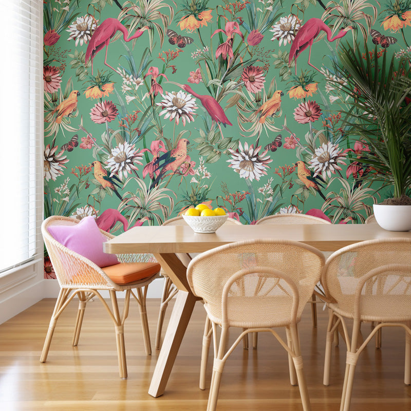 Dining room with a colorful flamingo wallpaper, wooden table, and wicker chairs.