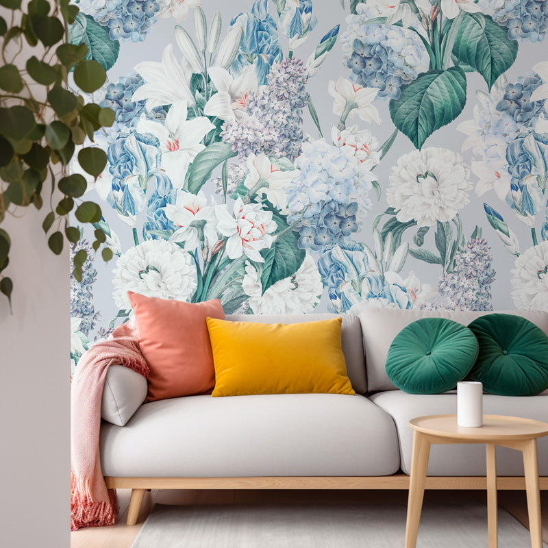 Sofa with colorful pillows against a blue floral wallpaper background