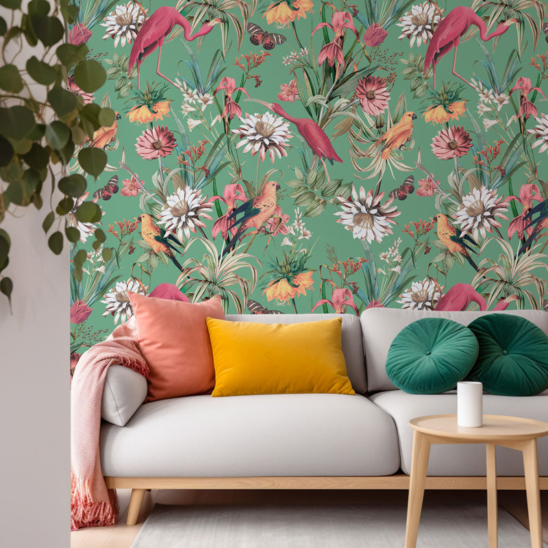 Living room with a sofa against a floral wallpaper wall.
