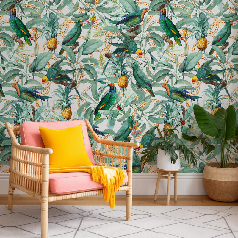 Chair with pink cushion and yellow blanket in front of tropical parrot wallpaper