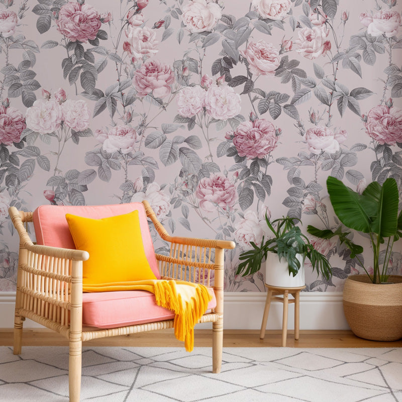 Wicker chair with pink cushion and yellow blanket against floral wallpaper