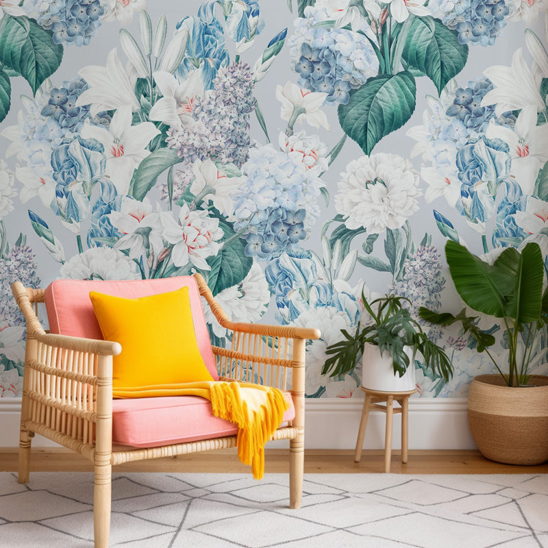 Chair with pink cushion and yellow blanket against floral wallpaper