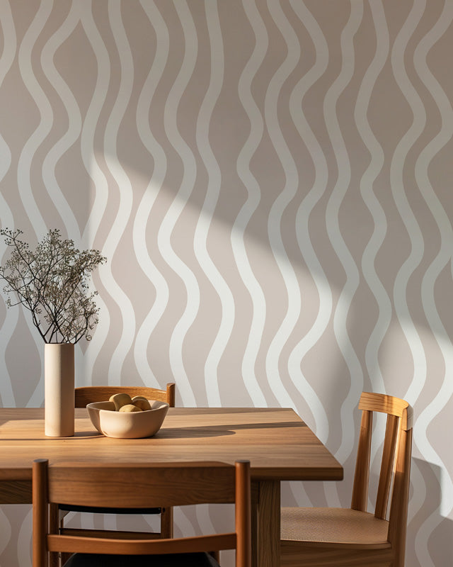 Dining room with wooden table and chairs against a wall with wavy wallpaper.