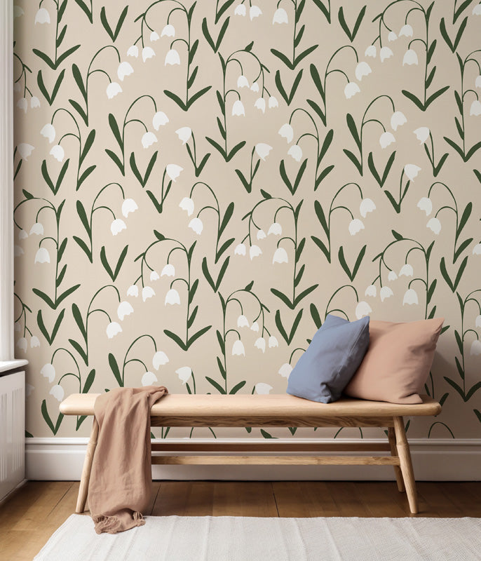 Floral wallpaper pattern in a room with a wooden bench and pillows.