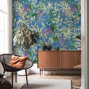 Modern interior with floral wallpaper, wooden cabinet, and chair.