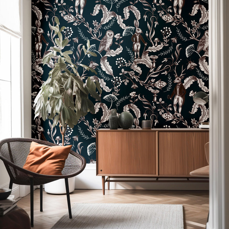 Room interior with vintage wallpaper featuring animals and plants, a wooden cabinet, and a chair with an orange pillow.