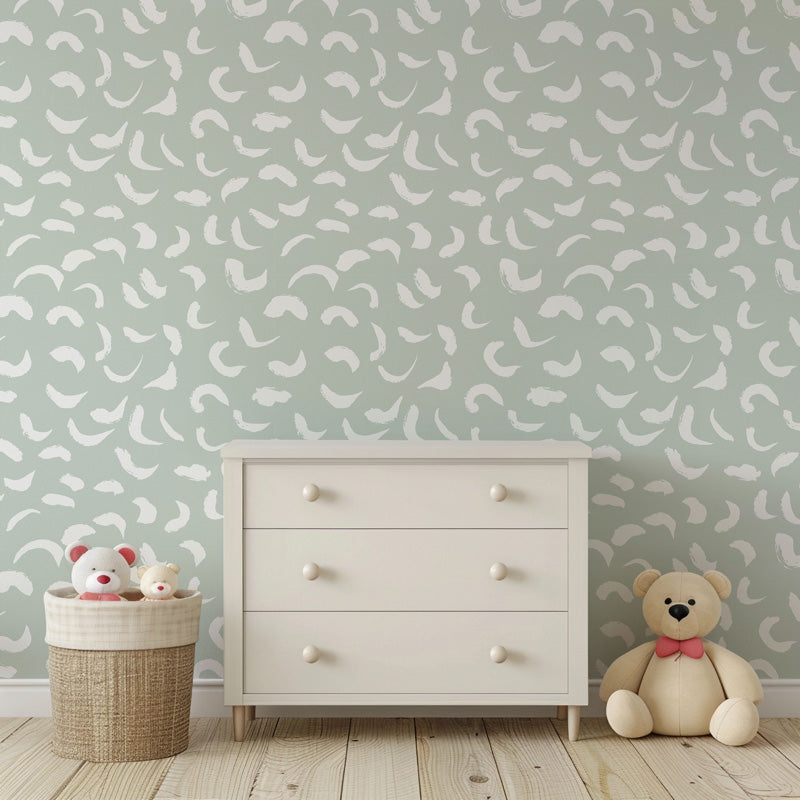 White dresser with teddy bear and basket against a modern wallpaper.