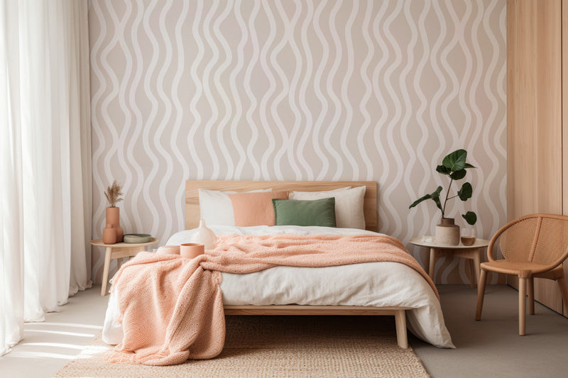 Bedroom with a bed, pink blanket, and striped wallpaper.