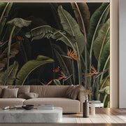 Living room with a beige sofa and a large tropical leaf wall mural.