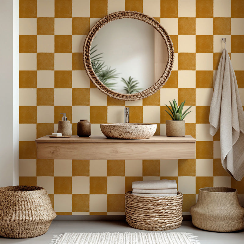Bathroom with a checkered yellow wallpaper, wooden vanity, and decorative items.