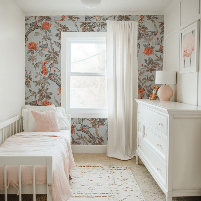 Children's bedroom with floral wallpaper, white furniture, and decorative elements.
