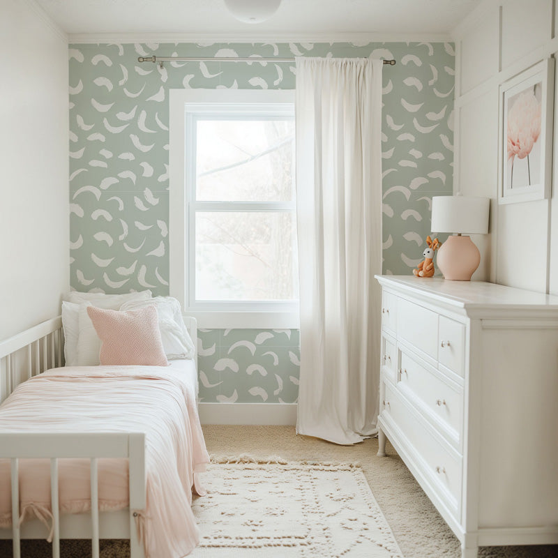 Children's bedroom with green wallpaper, white furniture, and a window.