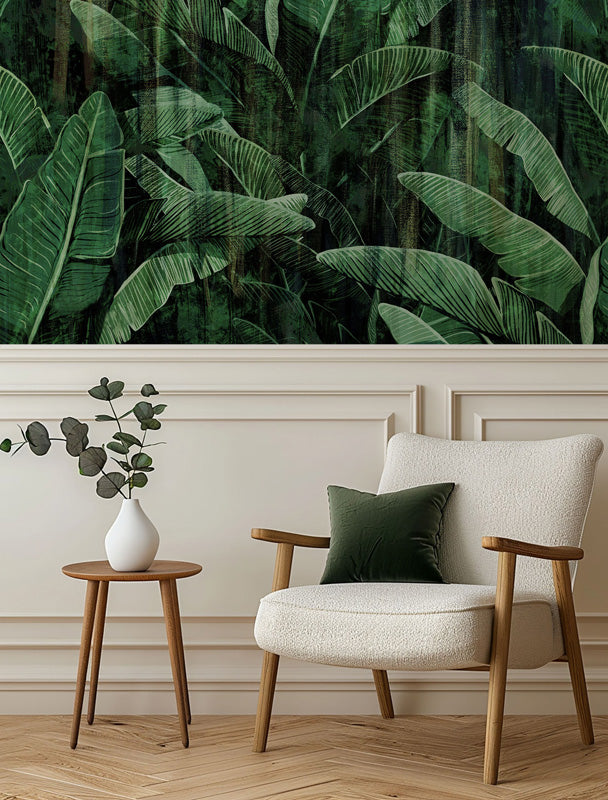 Modern living room with a chair, side table, and decorative plant against a wall with tropical leaf wallpaper.